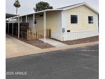 Charming single-story home featuring a covered carport and a cute picket fence at 8427 W Glendale Ave # 31, Glendale, AZ 85305