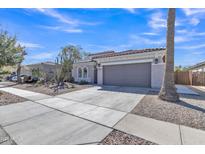 Charming single-story home featuring desert landscaping and a spacious two-car garage at 877 E La Costa Pl, Chandler, AZ 85249