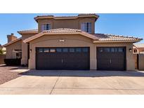 Inviting home featuring a two-car garage, tile roof, and neatly maintained landscaping at 1407 E Stanford Ave, Gilbert, AZ 85234