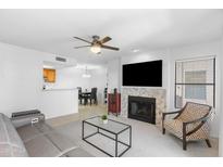 Open concept living room with tile fireplace, ceiling fan, and view to the kitchen and dining room at 14645 N Fountain Hills N Blvd # 215, Fountain Hills, AZ 85268