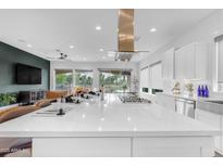 Kitchen boasts a large island, gas range, and stylish stainless steel vent hood at 187 E Santa Lucia Ln, Queen Creek, AZ 85140