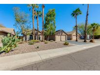 Charming single-story home featuring desert landscaping, mature trees, and a two-car garage at 3544 E Tonto Ln, Phoenix, AZ 85050