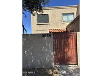 Exterior view of a two-story home featuring a gated entrance and visible house number at 3944 W Camelback Rd, Phoenix, AZ 85019