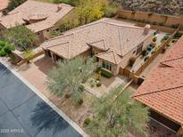 Stunning aerial view of a luxury home featuring a tile roof and desert landscaping at 7201 E Sandia Cir, Mesa, AZ 85207