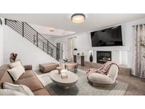 Stylish living room featuring a modern fireplace, sleek furniture, and plenty of natural light at 7650 E Williams Dr # 1011, Scottsdale, AZ 85255