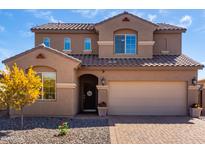 Inviting two-story home featuring a neutral-toned exterior, well-maintained landscaping, and a spacious two-car garage at 811 E Gold Dust Way, San Tan Valley, AZ 85143
