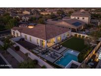 Aerial view showcases the outdoor living spaces of this home, featuring a pool, backyard, and patios at 10511 E Diffraction Ave, Mesa, AZ 85212