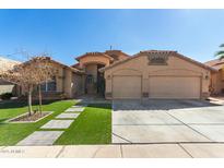 Charming single-story home featuring a three car garage and manicured lawn at 12749 W Sheridan St, Avondale, AZ 85392