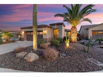 Charming desert home with a beautifully landscaped front yard and a two-car garage at 13065 W Lucia Dr, Peoria, AZ 85383