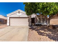 Charming single-story home with a two-car garage and low-maintenance desert landscaping at 1428 W Mesquite Ave, Apache Junction, AZ 85120