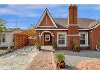 Charming brick home with a brick chimney and landscaped front yard, showcasing classic architectural details at 1533 W Culver St, Phoenix, AZ 85007