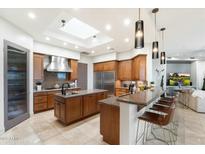 Spacious kitchen featuring an island, granite countertops, and modern stainless steel appliances at 15802 N 71St St # 754, Scottsdale, AZ 85254