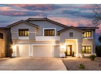 Charming two-story home with a three-car garage and well-manicured landscaping at twilight at 2046 E Avenida Del Sol --, Phoenix, AZ 85024