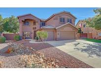 Spacious two-story home with a three car garage, landscaped yard and American flag at 25767 N 67Th Dr, Peoria, AZ 85383