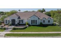 Charming single-story home with lush green lawn, neutral paint, and a tile roof at 3173 E Page Ave, Gilbert, AZ 85234