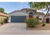 Charming single-story home featuring a two-car garage and a well-maintained front yard with colorful desert landscaping at 3847 W Yellow Peak Dr, San Tan Valley, AZ 85144