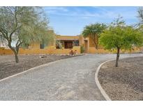 Charming desert home with gravel driveway and mature trees at 40627 N 6Th Ave, Phoenix, AZ 85086