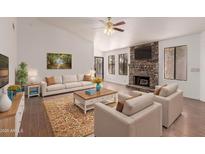 Bright living room with stone fireplace, large windows, and hardwood floors at 4450 E Amberwood Dr, Phoenix, AZ 85048