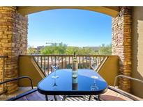 Balcony with a table and chairs, offering a view of the surrounding landscape and clear blue sky at 5450 E Deer Valley Dr # 2023, Phoenix, AZ 85054
