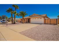 Charming single-story home featuring a two-car garage, mature palm trees, and a well-maintained yard at 547 E Sack Dr, Phoenix, AZ 85024