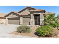 Charming home featuring a well-manicured front yard and a three car garage at 8014 W Ross Ave, Peoria, AZ 85382
