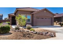 Charming home featuring a well-kept front yard with desert landscaping and a two-car garage at 12351 W Palmaire Ave, Glendale, AZ 85307