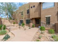 Two-story home boasts meticulously maintained desert landscaping and a charming walkway leading to the entrance at 13300 E Via Linda -- # 1054, Scottsdale, AZ 85259