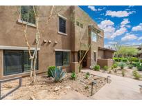 Beautiful two-story home featuring desert landscaping, a concrete walkway, and large windows at 13300 E Via Linda -- # 1054, Scottsdale, AZ 85259