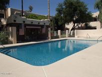 Community pool featuring clear blue water and a spacious surrounding deck for relaxation at 1449 E Highland Ave # 39, Phoenix, AZ 85014