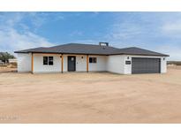 Newly renovated single-story home featuring a charming facade and a spacious two-car garage at 16567 N Slate Ln, Maricopa, AZ 85139