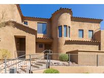 Lovely two-story stucco house featuring a tower, decorative tile roof, and attractive desert landscaping at 16600 N Thompson Peak Pkwy # 1072, Scottsdale, AZ 85260