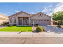 Charming single-story home featuring a two-car garage, manicured lawn, and desert landscaping at 1681 S Granite St, Gilbert, AZ 85295