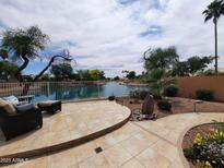 Inviting backyard patio with waterfront view, seating area, and desert landscaping at 1741 S Clearview Ave # 70, Mesa, AZ 85209