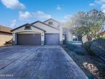 Inviting single-story home featuring a spacious three-car garage and desert landscaping at 17494 N Maddaloni Ave, Maricopa, AZ 85138