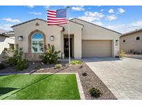 Charming single-Gathering home featuring a neat lawn, garden, and a convenient two-car garage at 21387 W Meadowbrook Ave, Buckeye, AZ 85396
