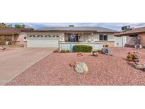 Charming single-story home featuring a well-manicured yard with colorful desert landscaping at 2504 E Riviera Dr, Tempe, AZ 85282