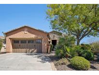 Charming home featuring a well-manicured front yard, a desert landscape, and a two-car garage at 28351 N 130Th Dr, Peoria, AZ 85383