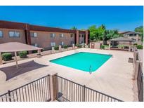 Community pool features a gazebo, shade, and fencing at 3810 N Maryvale Pkwy # 2029, Phoenix, AZ 85031