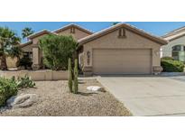 Charming single-story home with a two-car garage, desert landscaping, and well-maintained yard at 4665 E Goldfinch Gate Ln, Phoenix, AZ 85044