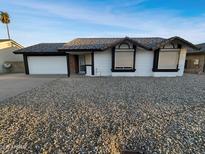 Charming single story home featuring a gravel front yard and attached two-car garage at 5654 W Villa Theresa Dr, Glendale, AZ 85308