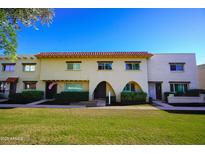 Charming townhome exterior with a red tile roof and well-maintained landscaping at 6961 E Osborn Rd # B, Scottsdale, AZ 85251