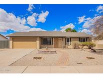 Charming single-story home with a well-maintained front yard, desert landscaping and a brick pathway at 8014 W Mescal St, Peoria, AZ 85345