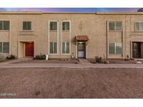 Charming townhome exterior features a red door and a textured facade at 8226 N 32Nd Dr, Phoenix, AZ 85051