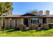 Charming home with a well-maintained front yard and brick facade at 907 W Laguna Dr, Tempe, AZ 85282