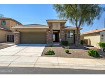 Charming single-story home featuring stone accents, a well-manicured yard, and a spacious two-car garage at 10635 W Eucalyptus Rd, Peoria, AZ 85383