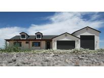Charming single-Gathering home featuring dormer windows and a three car garage, perfect for a modern lifestyle at 11142 E Copper Dust Trl, Florence, AZ 85132