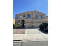 Two-story home featuring a well-manicured front yard, neutral color palette, and attached two-car garage at 19427 N Toya St, Maricopa, AZ 85138