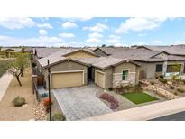 Charming home featuring a three-car garage, desert landscaping, and a beautifully paved driveway at 23434 N 76Th Way, Scottsdale, AZ 85255