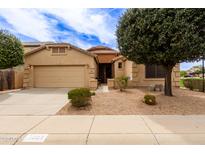 Charming single-story home featuring a well-manicured yard, neutral stucco, and an attached two-car garage at 3023 E Silversmith Trl, San Tan Valley, AZ 85143