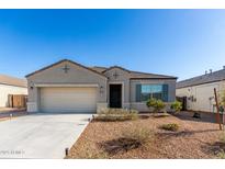 Charming single-story home with a well-maintained front yard and a two-car garage at 30323 W Sheila Ln, Buckeye, AZ 85396